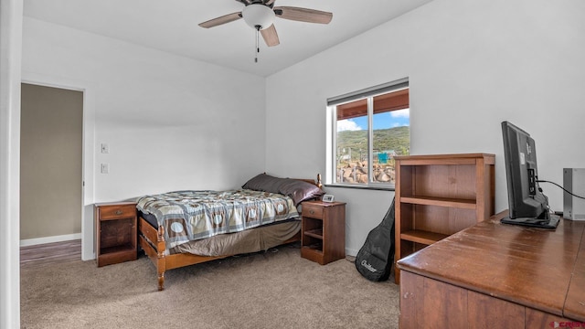 bedroom featuring ceiling fan and light carpet