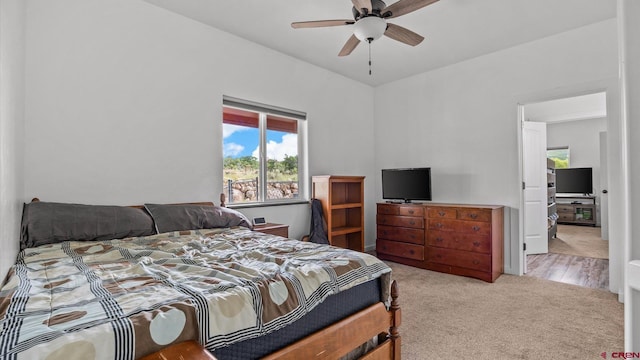 bedroom featuring ceiling fan and light colored carpet