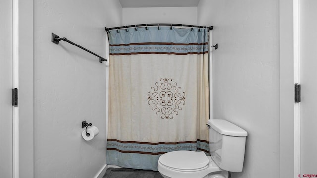 bathroom featuring tile patterned flooring and toilet