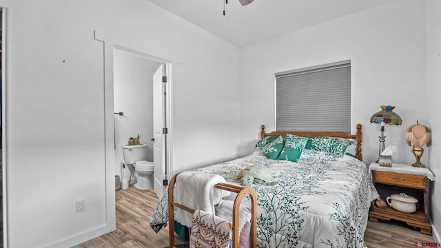 bedroom with ceiling fan, light hardwood / wood-style floors, and connected bathroom