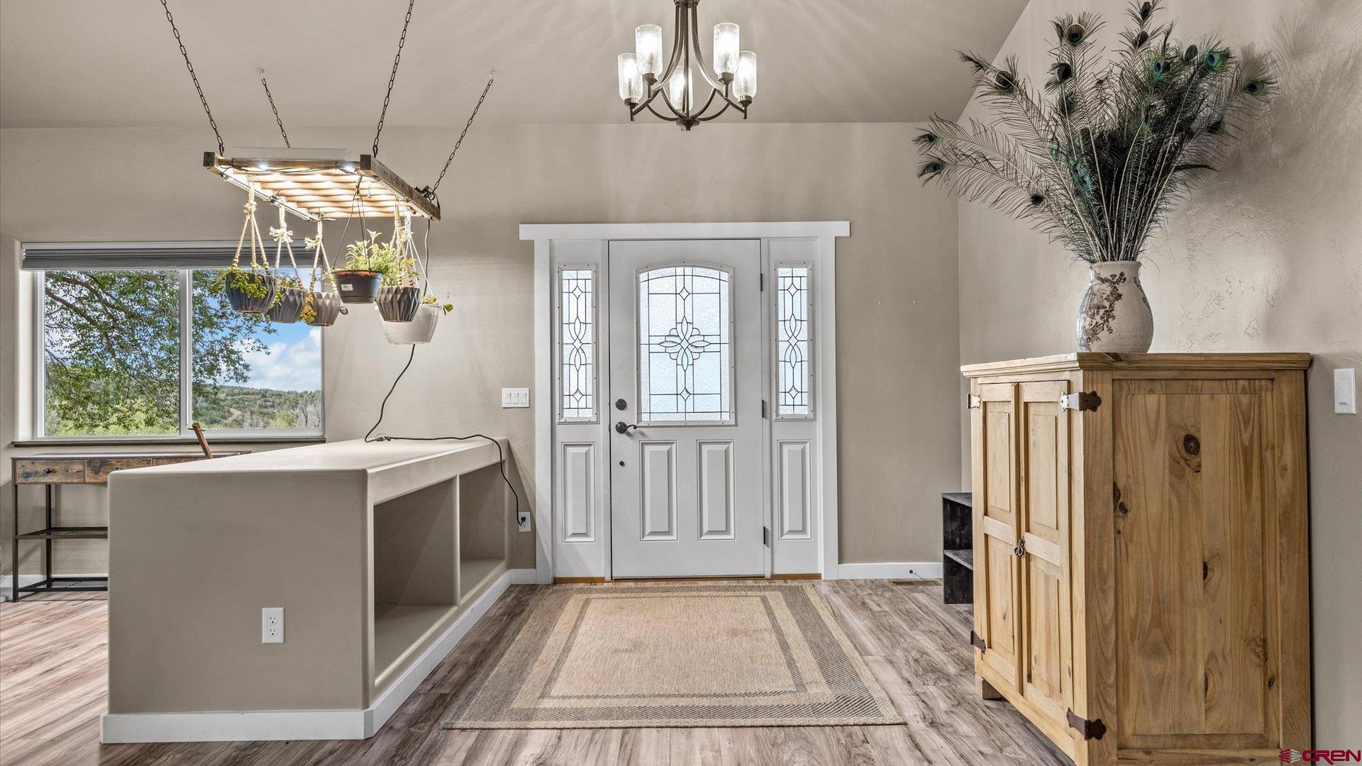 foyer featuring hardwood / wood-style flooring and a notable chandelier