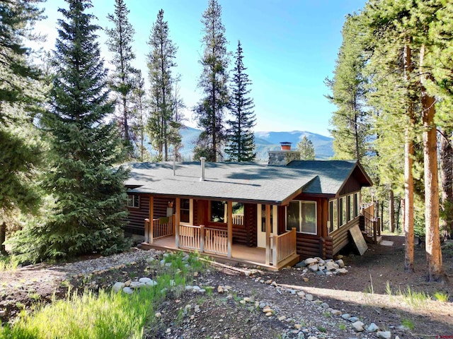 back of house featuring a mountain view and a porch