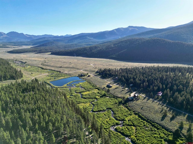 aerial view featuring a water and mountain view