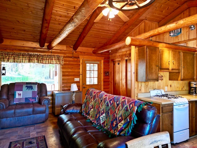 living room with vaulted ceiling with beams, ceiling fan, and wood ceiling