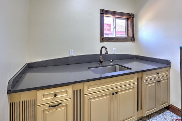 kitchen featuring dark countertops and a sink