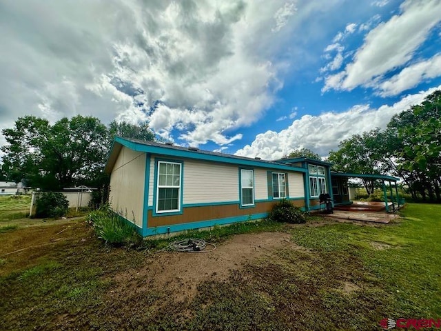 view of side of home featuring a yard