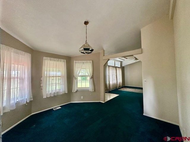 carpeted spare room with vaulted ceiling