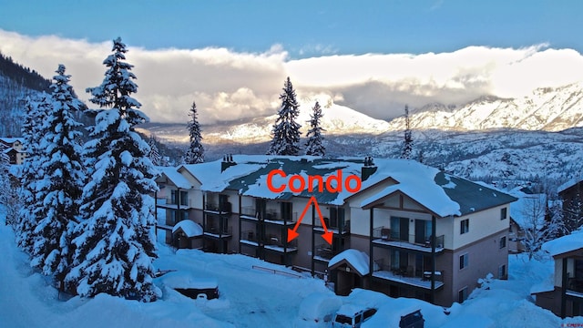 exterior space with a balcony and a mountain view