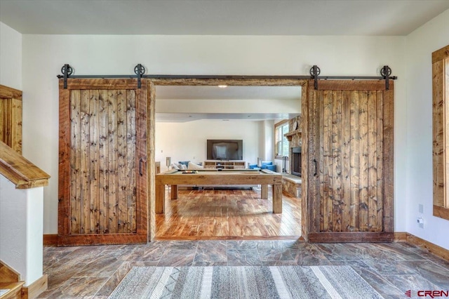 interior space featuring a barn door and wood-type flooring