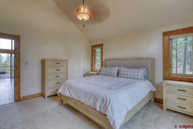 bedroom featuring light colored carpet, multiple windows, and ceiling fan