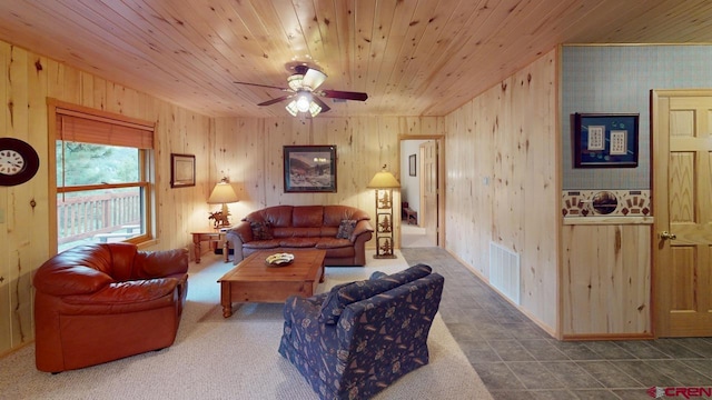 tiled living room featuring wood walls, ceiling fan, and wooden ceiling