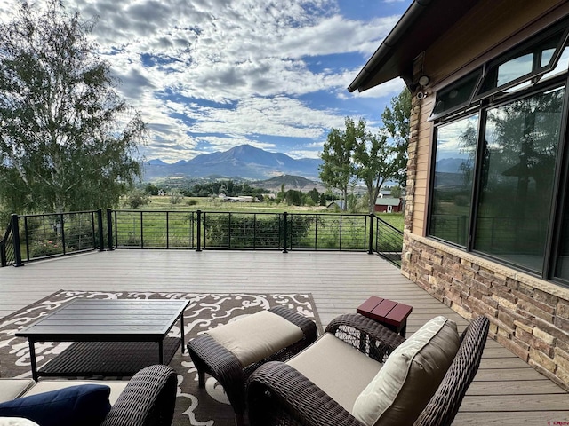 view of patio with a deck with mountain view and outdoor lounge area