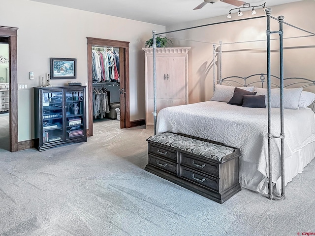 bedroom with a closet, ceiling fan, and light carpet