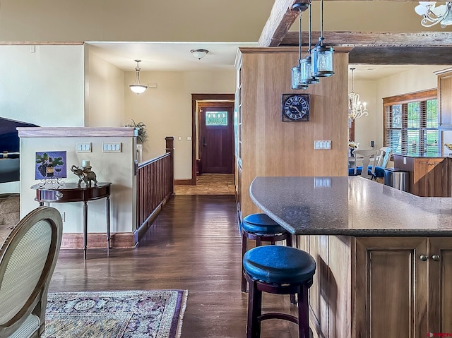 interior space with an inviting chandelier, decorative light fixtures, and dark hardwood / wood-style flooring