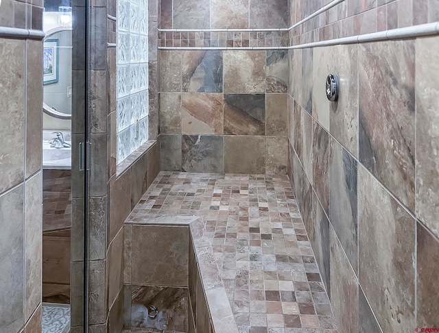 bathroom with a tile shower