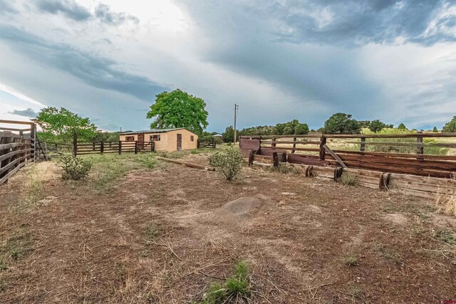 view of yard with a rural view