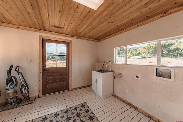 clothes washing area with wooden ceiling, light tile patterned floors, sink, hookup for an electric dryer, and washer hookup