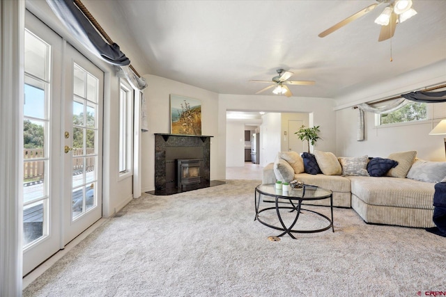 living room featuring ceiling fan and carpet