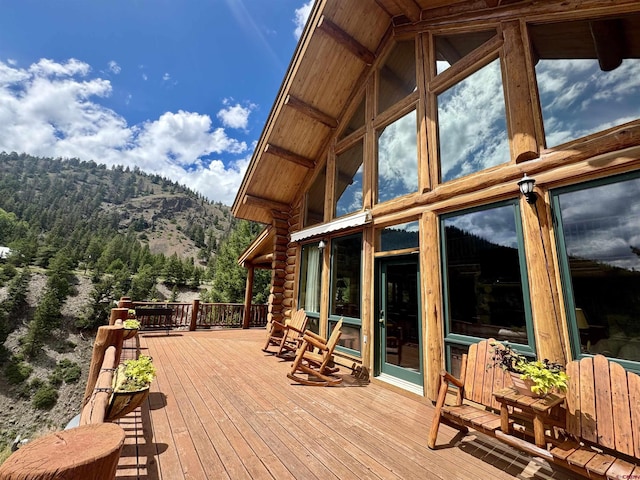 wooden terrace with a mountain view and a wooded view