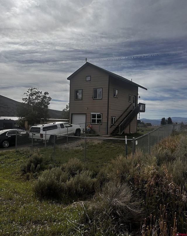 back of property with a garage