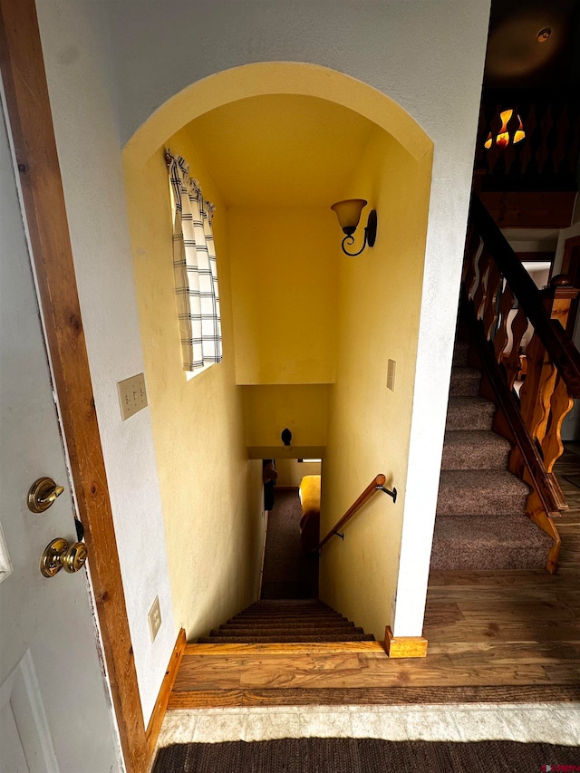 stairs featuring wood-type flooring