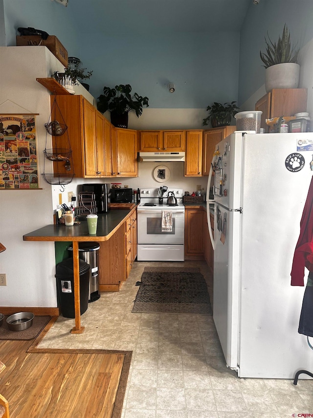 kitchen with white appliances and light hardwood / wood-style floors