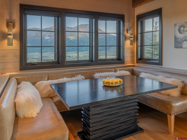 interior space featuring breakfast area, hardwood / wood-style flooring, and wood walls