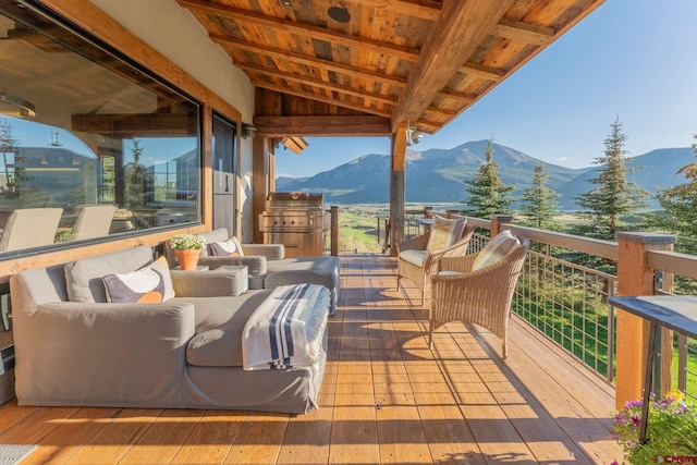 wooden terrace with an outdoor living space and a mountain view