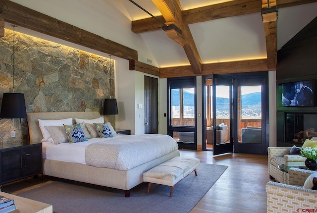 bedroom with beamed ceiling, hardwood / wood-style floors, high vaulted ceiling, and access to outside