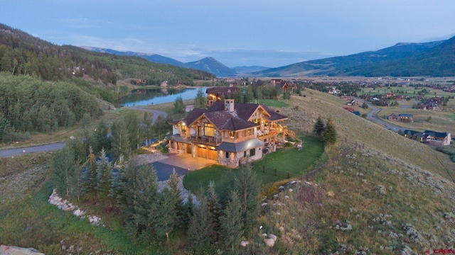 aerial view featuring a water and mountain view