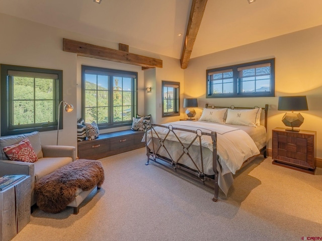 bedroom with carpet flooring, vaulted ceiling with beams, and multiple windows