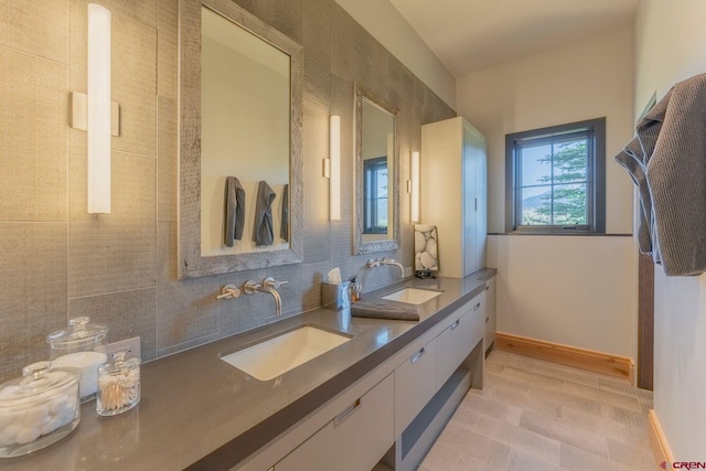 1251 Skyland Dr, Crested Butte, CO 81224 - bathroom with baseboards, tasteful backsplash, double vanity, and a sink
