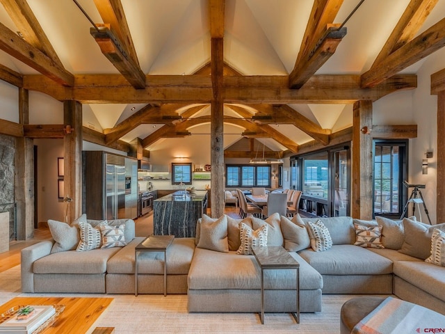 living room featuring high vaulted ceiling, hardwood / wood-style flooring, and beam ceiling