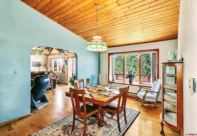 dining space featuring wood ceiling, vaulted ceiling, baseboard heating, and light hardwood / wood-style floors