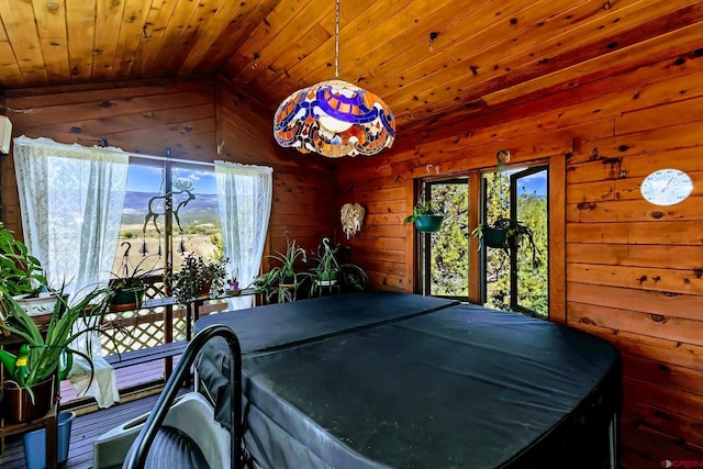 interior space with wood ceiling, wooden walls, and vaulted ceiling