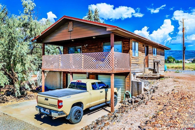 view of front of property with a mountain view and a garage