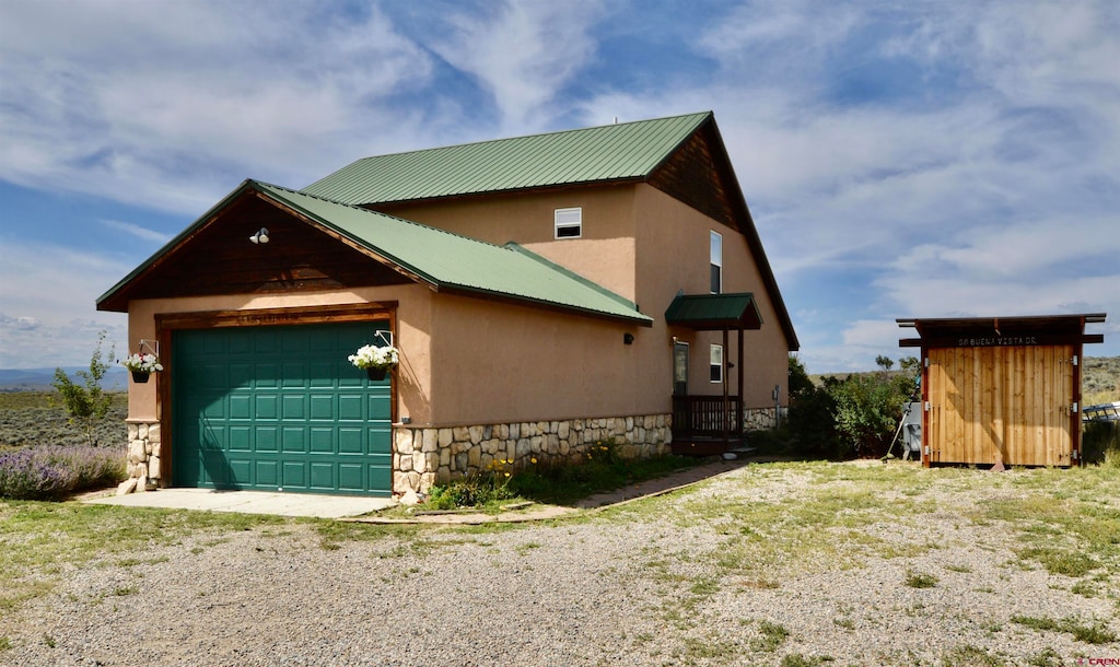 exterior space featuring a garage and a storage shed