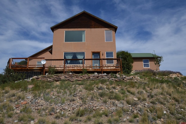 back of house featuring a deck