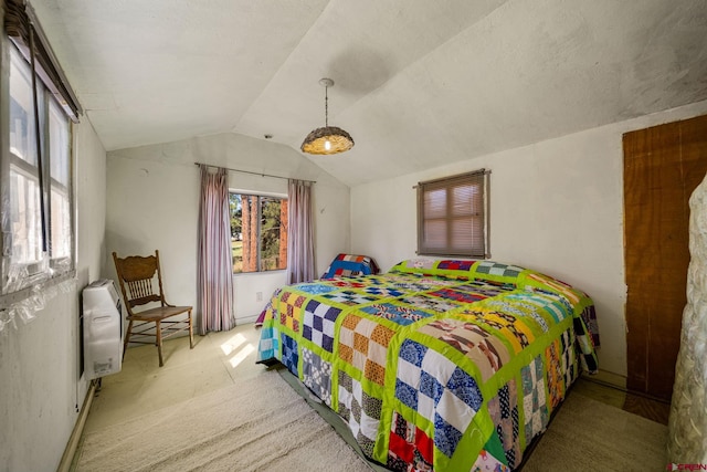 carpeted bedroom featuring radiator heating unit and vaulted ceiling