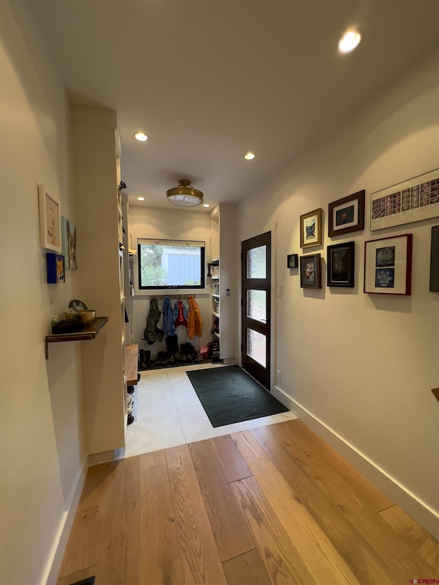 doorway with recessed lighting, baseboards, and light wood-style flooring