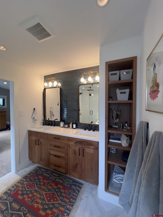 bathroom with a sink, visible vents, recessed lighting, and double vanity