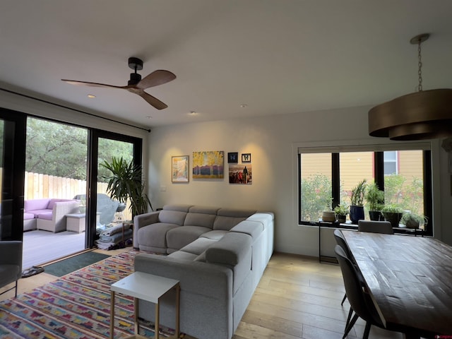 living room featuring light wood-style floors and ceiling fan