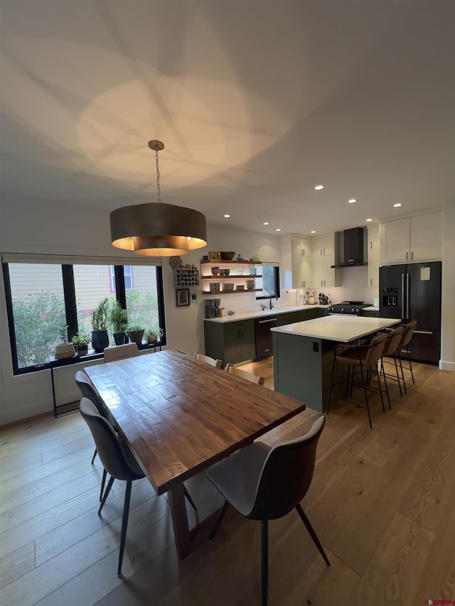 dining space featuring recessed lighting and light wood-style floors