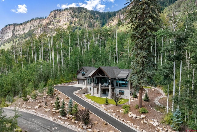 view of front facade featuring a mountain view and a balcony