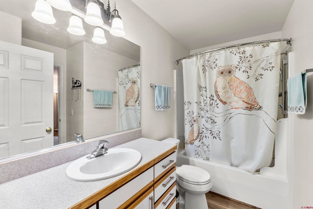 full bathroom with vanity, toilet, hardwood / wood-style floors, and shower / bath combo with shower curtain