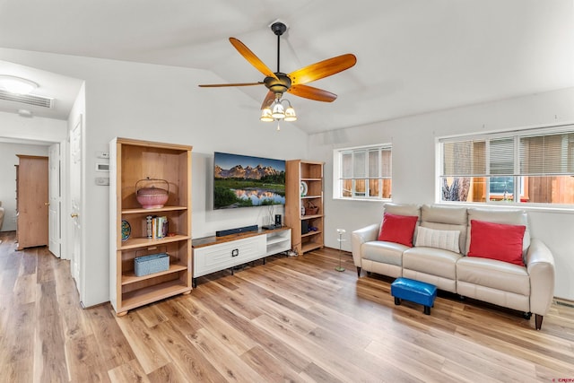 living room with lofted ceiling, light hardwood / wood-style flooring, and ceiling fan