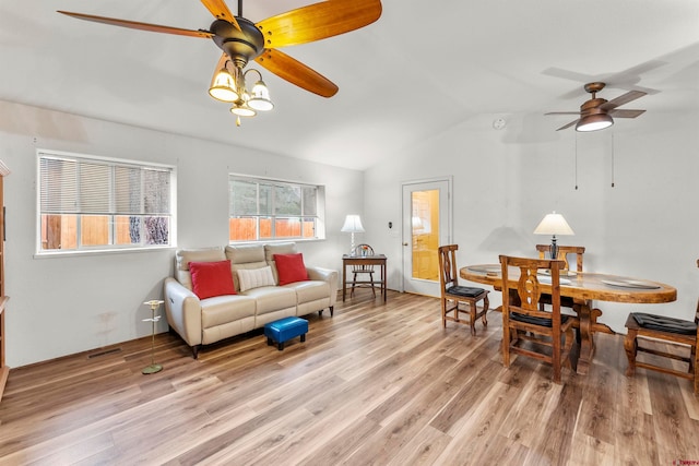 living room featuring lofted ceiling, light hardwood / wood-style flooring, and ceiling fan