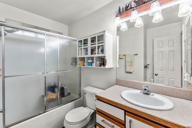 full bathroom with vanity, toilet, and bath / shower combo with glass door