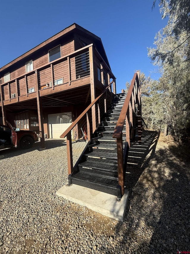 exterior space with stairway and an attached garage