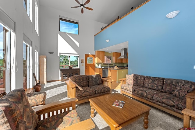 living room with light colored carpet, a high ceiling, and ceiling fan